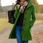 Women’s long winter coat in green with button-front closure and lapels