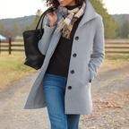 Women’s long winter coat in light gray with button-front closure and lapels
